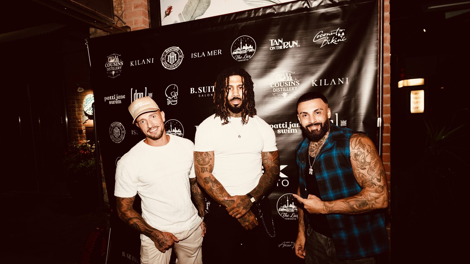 Guests on the Escobar x ViCES Swim Week 2026 step-and-repeat in Toronto