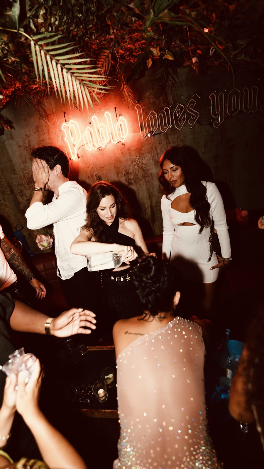 Crowd under the neon signage inside Escobar Toronto