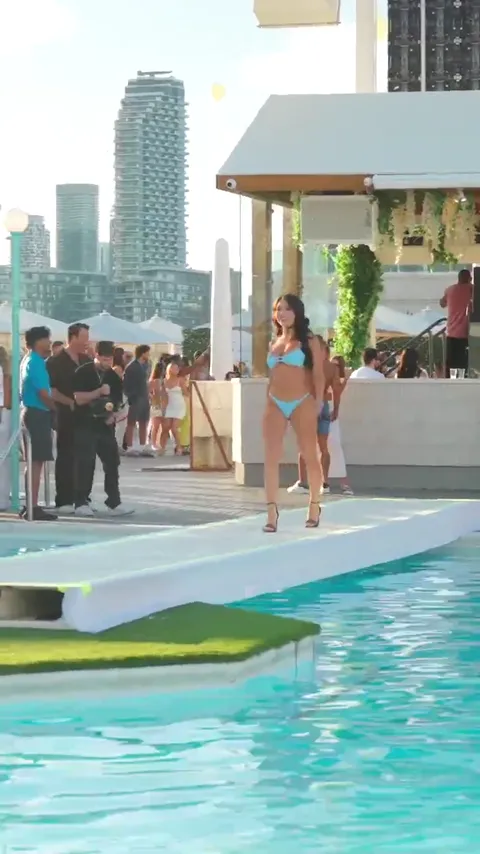 Agua Swim runway walk over the water at ViCES Swim Week 2025.