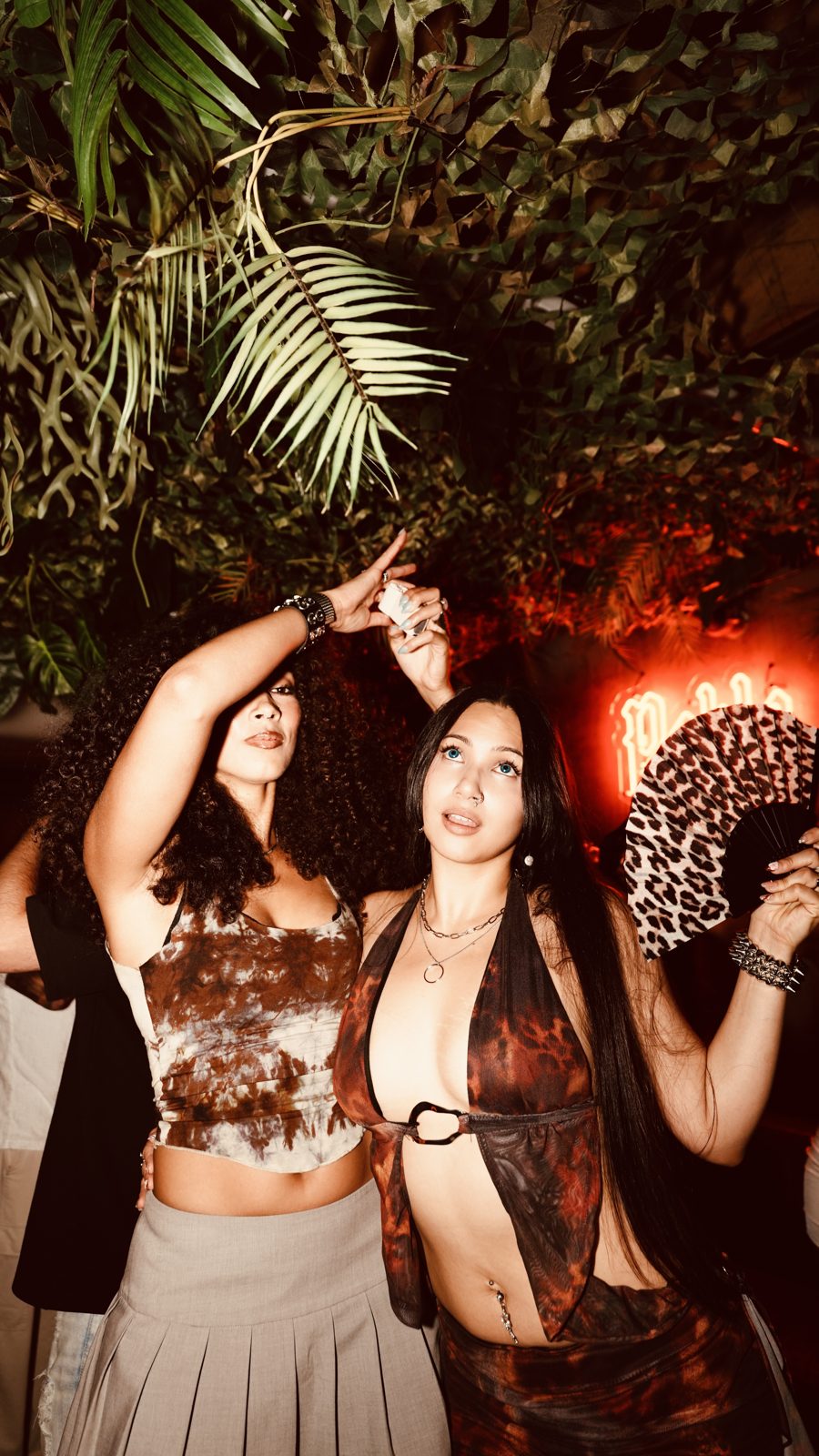 Guests dancing under the red lights of the main room